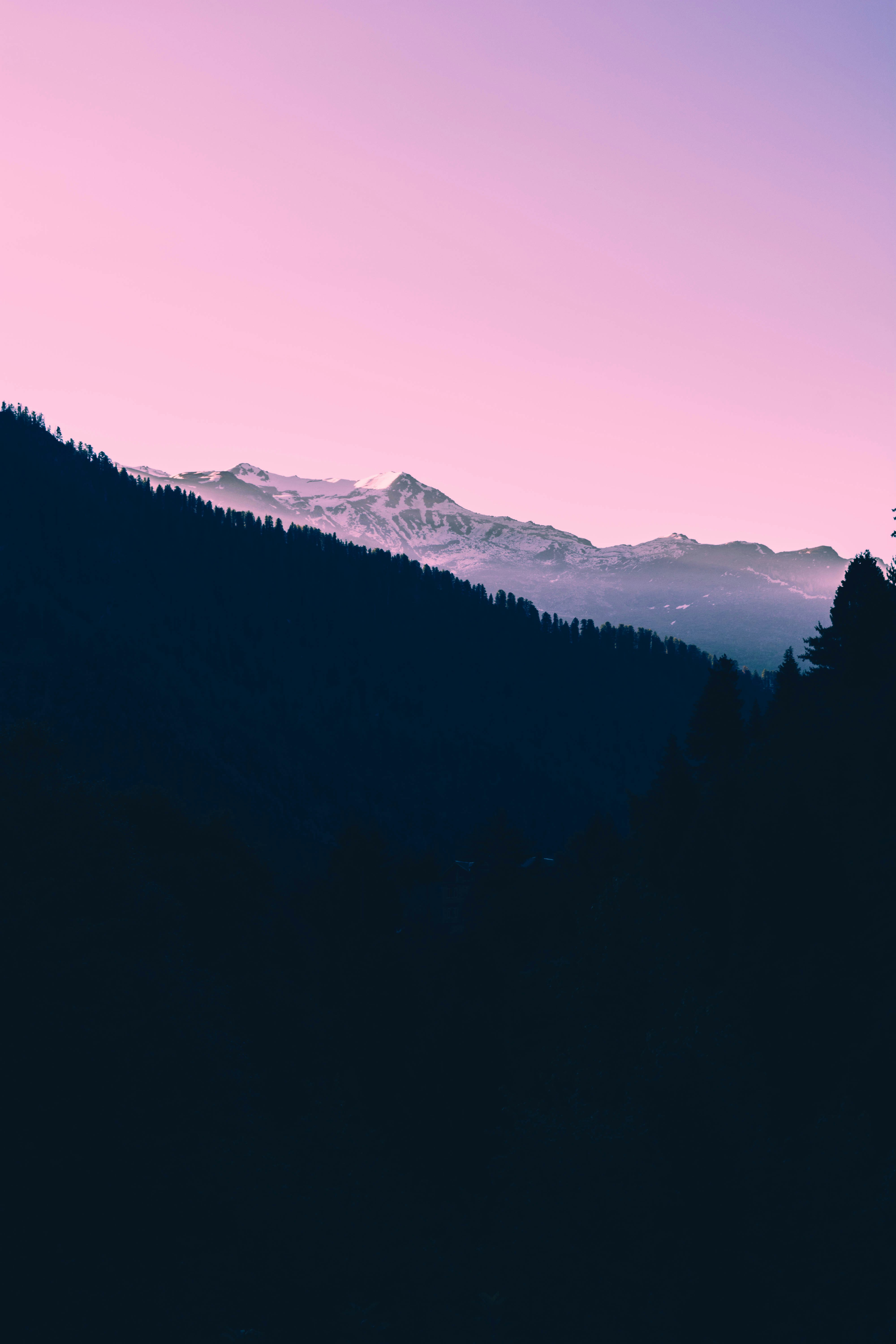 Dark sunset on snow covered mountain